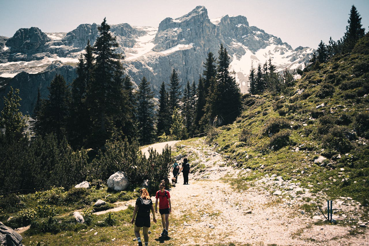 Hikers enjoy a stunning winter hike in the snow-covered Alps with majestic mountains in view.